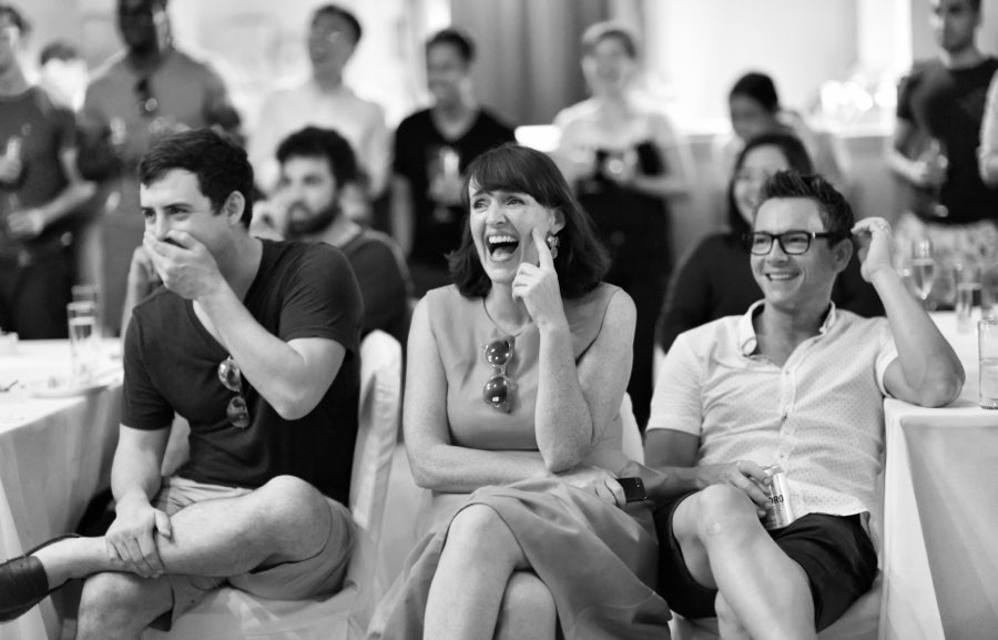 Colleagues laughing at speech by founder, Hong Kong